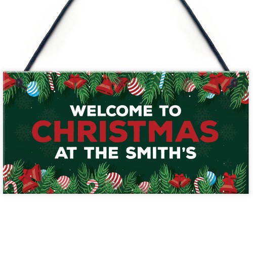 Welcome Christmas Sign At The 'Surname' Personalised Decoration