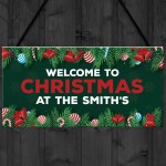 Welcome Christmas Sign At The 'Surname' Personalised Decoration