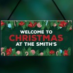 Welcome Christmas Sign At The 'Surname' Personalised Decoration