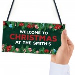 Welcome Christmas Sign At The 'Surname' Personalised Decoration