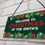 Welcome Christmas Sign At The 'Surname' Personalised Decoration