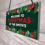 Welcome Christmas Sign At The 'Surname' Personalised Decoration